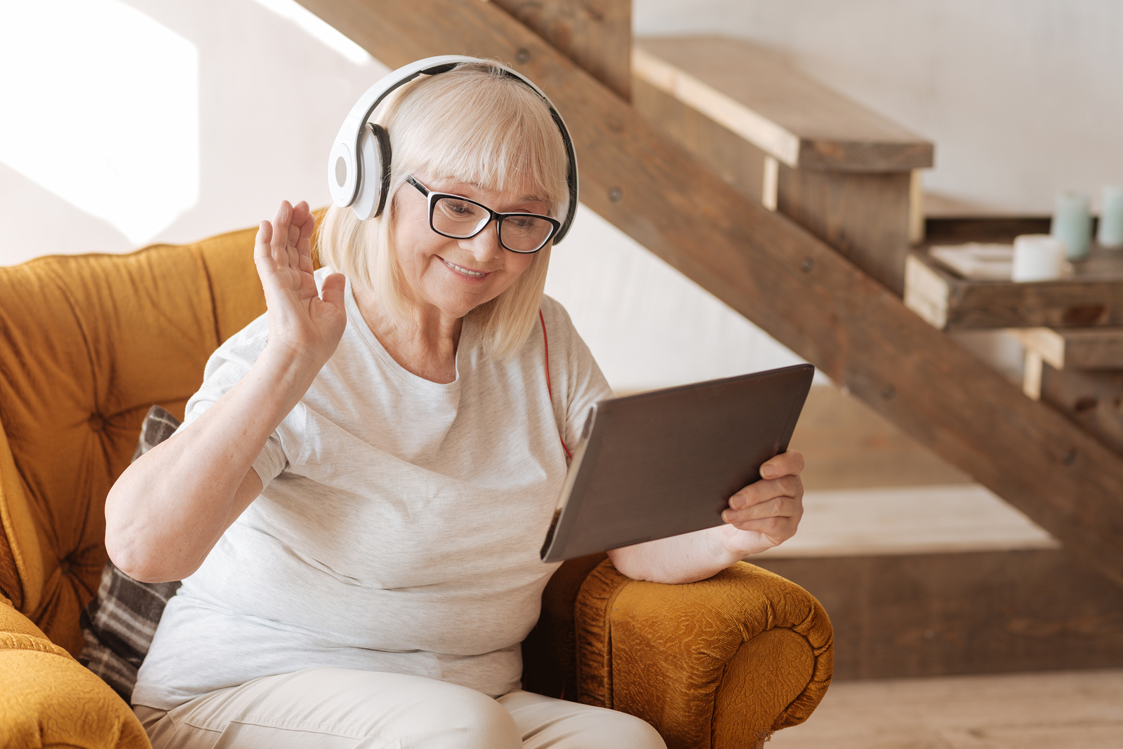 Elderly woman speaking to her care team via the m.Care tablet