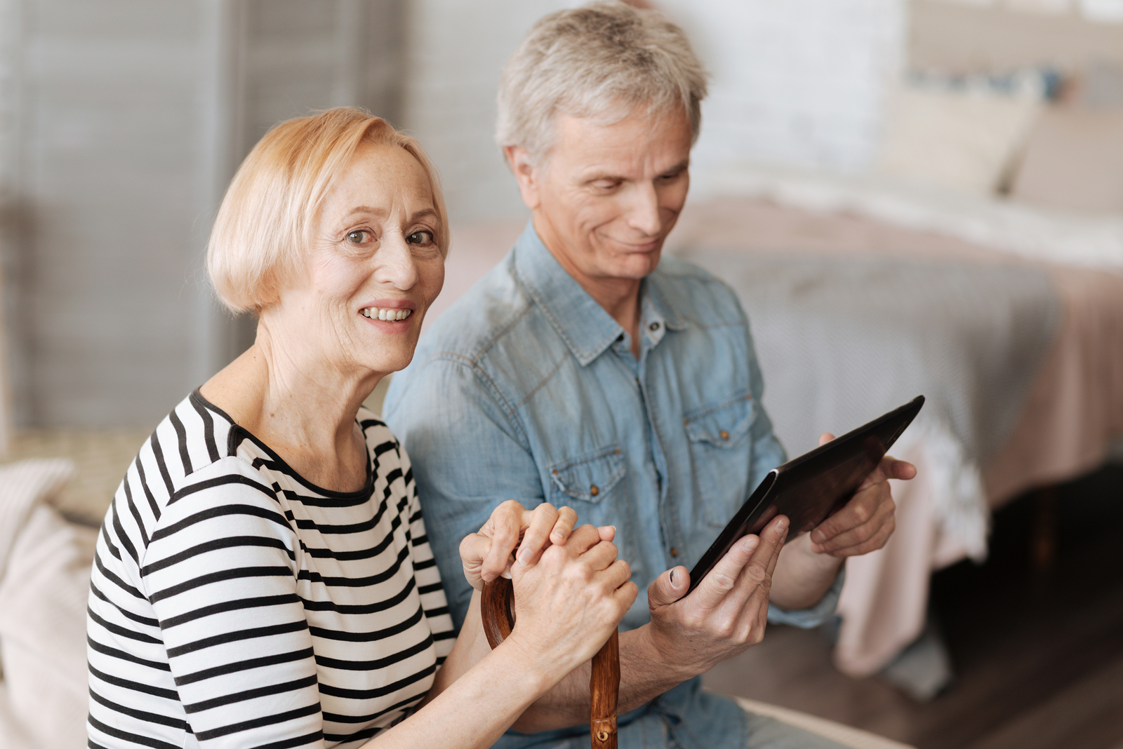 Elderly couple using m.Care tablet at home