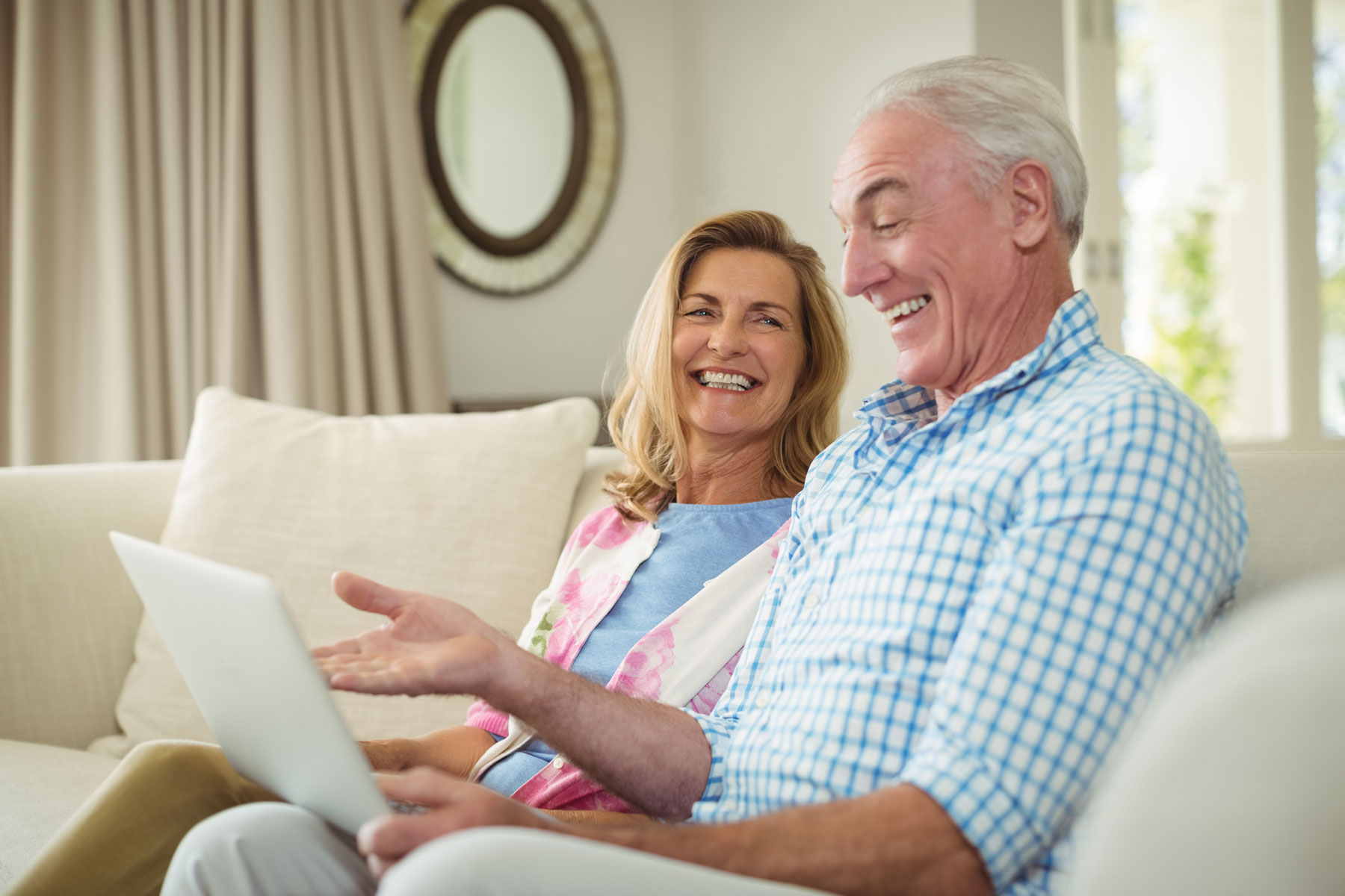 Senior Couple at home using m.Care remote patient monitoring technology